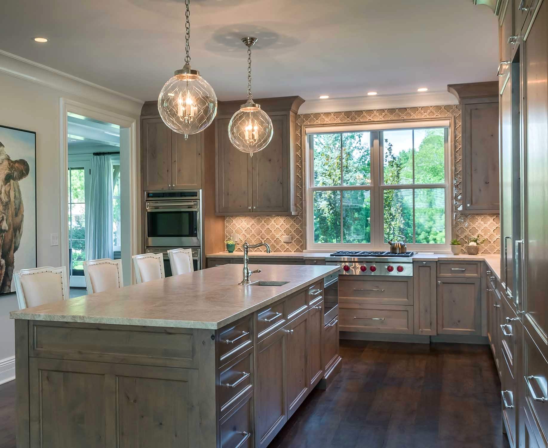 Northbrook rustic chic kitchen with light brown cabinets and eat-in island