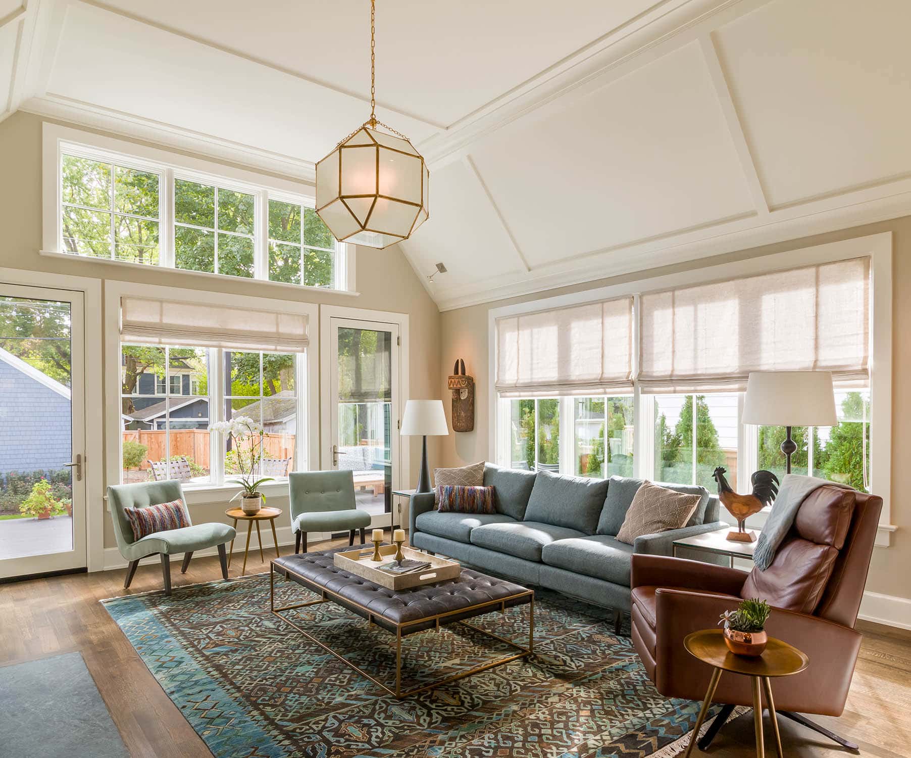 Evanston Modern farmhouse living room with barrel-vaulted ceilings, wall of windows and doors to back deck