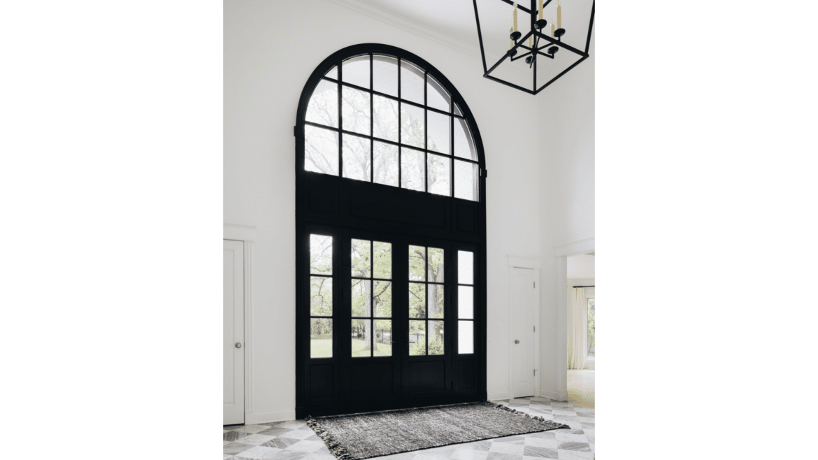 White entry foyer with black double front doors with multiple windows and large arch of windows, checkerboard style gray and white tile floor