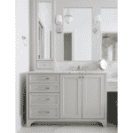 Gray cabinet vanity with double mirror in asymmetrical design with sconces and a single sink
