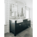 Double farmhouse apron sink primary bathroom vanity with dark lower cabinet, large floor tile and white shiplap wall