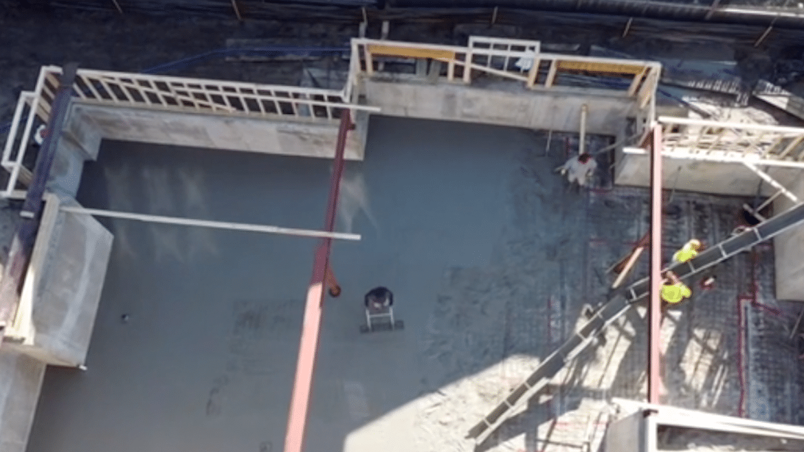 Drone view of basement foundation cement pouring process.
