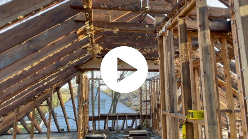 Play button page of video about home deconstruction in Kenilworth showing attic stripped down to the studs